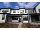 Townhome featuring a welcoming front porch, complemented by dark window frames and attractive modern landscaping at 133 Armstrong Rd, Belmont, NC 28012
