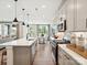 Well-lit kitchen featuring stainless steel appliances, a large island, modern lighting, and a breakfast bar for casual dining at 133 Armstrong Rd, Belmont, NC 28012
