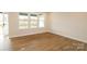 Bright living room with hardwood floors, large windows, and views of the landscaped lawn at 133 Armstrong Rd, Belmont, NC 28012