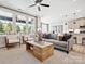 Open-concept living room featuring a cozy sofa, natural light, and an eat-in kitchen at 133 Armstrong Rd, Belmont, NC 28012