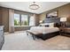 Spacious main bedroom with a large bed, neutral tones, and bright natural light from large windows at 133 Armstrong Rd, Belmont, NC 28012