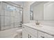 Bright bathroom featuring a shower-tub, white vanity with a large mirror, and marble-like flooring at 104 Brooke Forest Ct, Mooresville, NC 28115