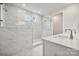 Modern bathroom with white marble tile shower, glass enclosure, and sleek white vanity at 104 Brooke Forest Ct, Mooresville, NC 28115