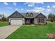 Charming single-Gathering home with stone accents, a well-manicured lawn, and inviting curb appeal at 104 Brooke Forest Ct, Mooresville, NC 28115