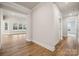 Bright hallway leading to open living area featuring hardwood floors and neutral wall color at 104 Brooke Forest Ct, Mooresville, NC 28115