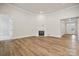 Open-concept living room featuring a fireplace, hardwood floors, and easy access to the kitchen at 104 Brooke Forest Ct, Mooresville, NC 28115