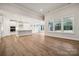 Bright, open living space featuring hardwood floors, neutral walls, and ample natural light at 104 Brooke Forest Ct, Mooresville, NC 28115