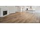 Spacious open-concept living area with fireplace, hardwood floors, and open access to the kitchen at 104 Brooke Forest Ct, Mooresville, NC 28115