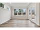 Cozy sunroom with large windows offering scenic views and hardwood flooring at 104 Brooke Forest Ct, Mooresville, NC 28115