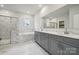 Elegant bathroom with double vanity, soaking tub, and marble tile at 108 Brooke Forest Ct, Mooresville, NC 28115