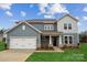 Two-story home with gray siding, white garage door, and landscaping at 108 Brooke Forest Ct, Mooresville, NC 28115