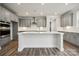 Modern kitchen with island, stainless steel appliances, and gray cabinets at 108 Brooke Forest Ct, Mooresville, NC 28115