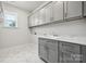 Laundry room with gray cabinets and quartz countertops at 108 Brooke Forest Ct, Mooresville, NC 28115