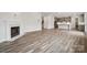 Open living space with hardwood floors and a marble fireplace at 108 Brooke Forest Ct, Mooresville, NC 28115