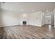 Living room with hardwood floors, fireplace, and access to kitchen at 108 Brooke Forest Ct, Mooresville, NC 28115