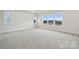 Bright bedroom featuring multiple windows and plush carpeting at 232 E Warfield Dr, Mooresville, NC 28115