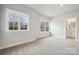 Bright bedroom featuring windows, carpet flooring, and ensuite bath at 232 E Warfield Dr, Mooresville, NC 28115