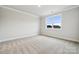 Spacious bedroom featuring a large window and neutral carpet at 232 E Warfield Dr, Mooresville, NC 28115