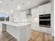 Bright kitchen features white cabinets, quartz countertops, and stainless steel appliances at 232 E Warfield Dr, Mooresville, NC 28115