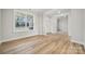 Bright living room featuring hardwood floors, large windows, and white trim, creating an inviting and airy space at 232 E Warfield Dr, Mooresville, NC 28115