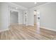 Spacious living room shows an open layout with hardwood floors, multiple entryways, and neutral paint, offering versatility at 232 E Warfield Dr, Mooresville, NC 28115