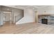 Living room with fireplace, wood floors, staircase and entry door at 232 E Warfield Dr, Mooresville, NC 28115