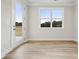 Bright, empty room with wood-look floors and double glass doors with a large window at 232 E Warfield Dr, Mooresville, NC 28115