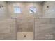 Modern shower with dual shower heads, tiled walls, and a glass enclosure at 232 E Warfield Dr, Mooresville, NC 28115