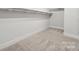 Walk-in closet featuring built-in shelving and carpet flooring at 232 E Warfield Dr, Mooresville, NC 28115