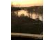 Stunning sunset view over serene lake with houses and boats at 9004 Cebu Ct, Tega Cay, SC 29708