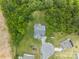 Bird's eye view of a house, driveway, and cul-de-sac surrounded by lush trees and greenery at 1302 Devonmere Pl, Salisbury, NC 28144