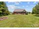 Large backyard with grassy area and fire pit at 1302 Devonmere Pl, Salisbury, NC 28144