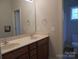 Double vanity bathroom with tan countertop and mirror at 1302 Devonmere Pl, Salisbury, NC 28144