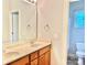 Bathroom featuring double sinks, wood cabinets, and a bright window at 1302 Devonmere Pl, Salisbury, NC 28144