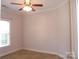 Bright bedroom with window, ceiling fan, and neutral wall paint at 1302 Devonmere Pl, Salisbury, NC 28144