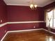 Formal dining room with hardwood floors and burgundy walls at 1302 Devonmere Pl, Salisbury, NC 28144