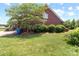 Brick home exterior featuring landscaped yard with manicured bushes and mature shade tree at 1302 Devonmere Pl, Salisbury, NC 28144