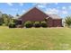 Charming brick home with a well-manicured lawn and neatly trimmed bushes at 1302 Devonmere Pl, Salisbury, NC 28144