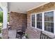 Covered porch with stone veneer and rocking chairs at 1302 Devonmere Pl, Salisbury, NC 28144