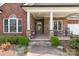 Inviting front porch with stone columns and rocking chairs at 1302 Devonmere Pl, Salisbury, NC 28144