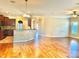 Open-concept living room with hardwood floors and a view to the kitchen at 1302 Devonmere Pl, Salisbury, NC 28144