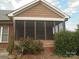 Charming porch with a brick foundation, screened windows, and landscaped surroundings for outdoor enjoyment at 1302 Devonmere Pl, Salisbury, NC 28144