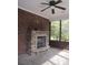 Screened porch with stone fireplace and ceiling fan at 1302 Devonmere Pl, Salisbury, NC 28144