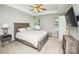 Spacious bedroom with a large bed, nightstand, and TV at 4816 Windchase Ln, Charlotte, NC 28269