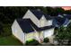 Two-story house with a beige exterior, black roof, and a well-manicured lawn at 4816 Windchase Ln, Charlotte, NC 28269