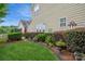 Landscaped backyard with lush greenery, a well-maintained lawn, and a privacy hedge at 3203 Kelsey Plz, Kannapolis, NC 28081