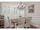 Bright dining room with wood table and white chairs near kitchen at 3203 Kelsey Plz, Kannapolis, NC 28081