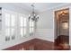 Bright dining room with hardwood floors, chandelier, and plantation shutters at 3203 Kelsey Plz, Kannapolis, NC 28081
