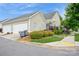 Tan house exterior with a two-car garage and well-manicured landscaping at 3203 Kelsey Plz, Kannapolis, NC 28081