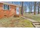 Brick exterior with walk-up entrance to the back of the home, framed by mature trees at 3210 Marlborough Rd, Charlotte, NC 28208